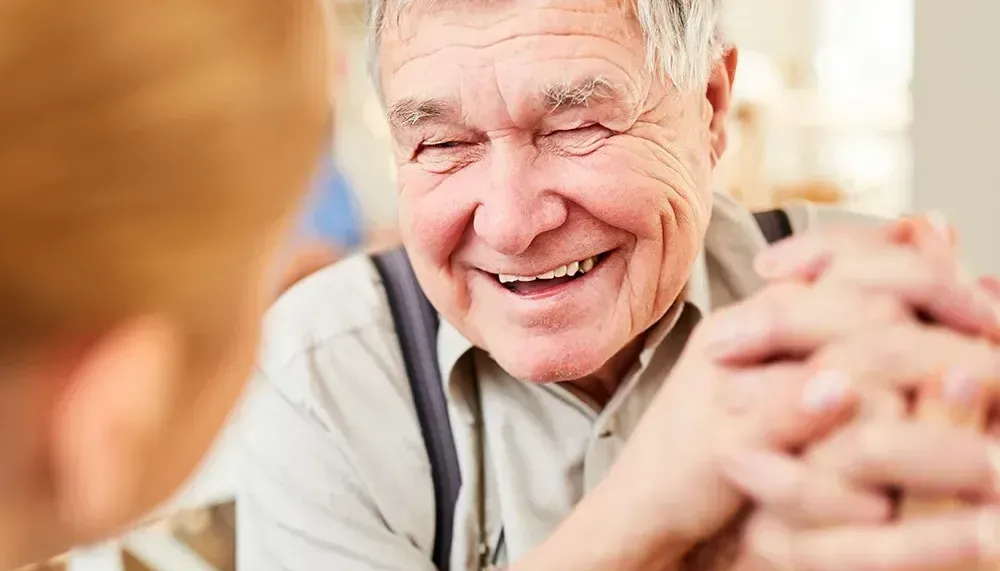 smiling man sitting at table with woman